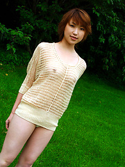 Cute asian babe shows off her naked plump tits under her sweater