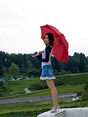 Cute Asian teen model in a mini skirt shows nice ass
